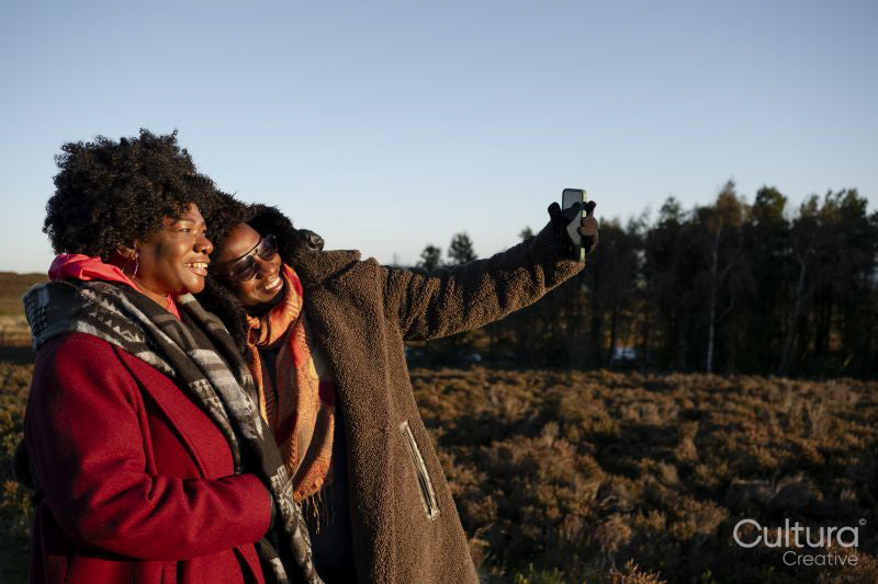 Two senior women taking selfie in moorland