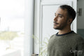 Mature man looking through window