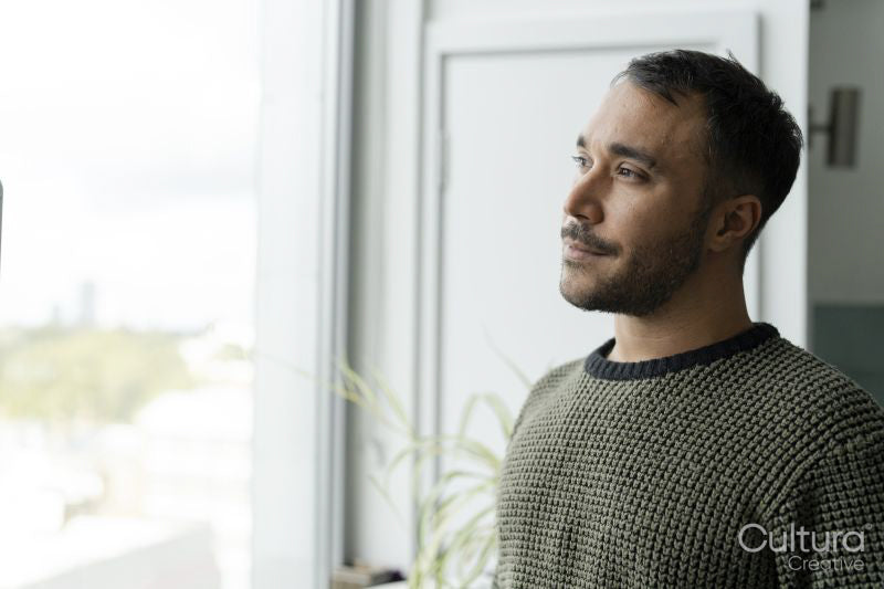 Mature man looking through window