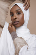 Studio portrait of young woman wearing white hijab