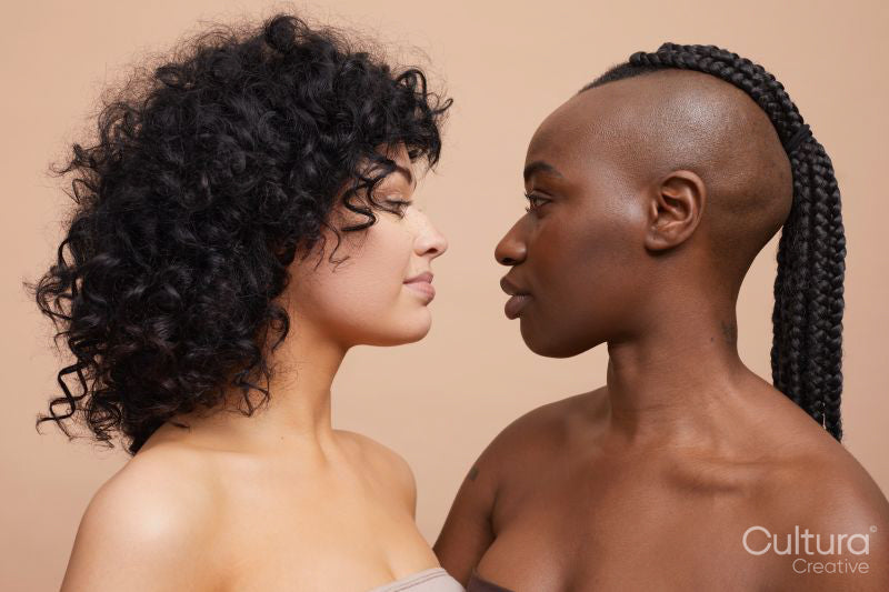 Studio portrait of beautiful women standing face to face