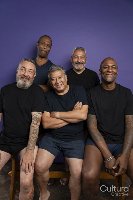 Portrait of smiling men in black t-shirts against purple background