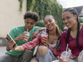 Friends taking selfie while drinking smoothie