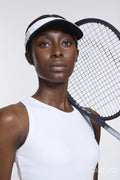 Studio portrait of athletic woman with tennis racket