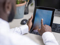 Close-up of hands using computer at desk