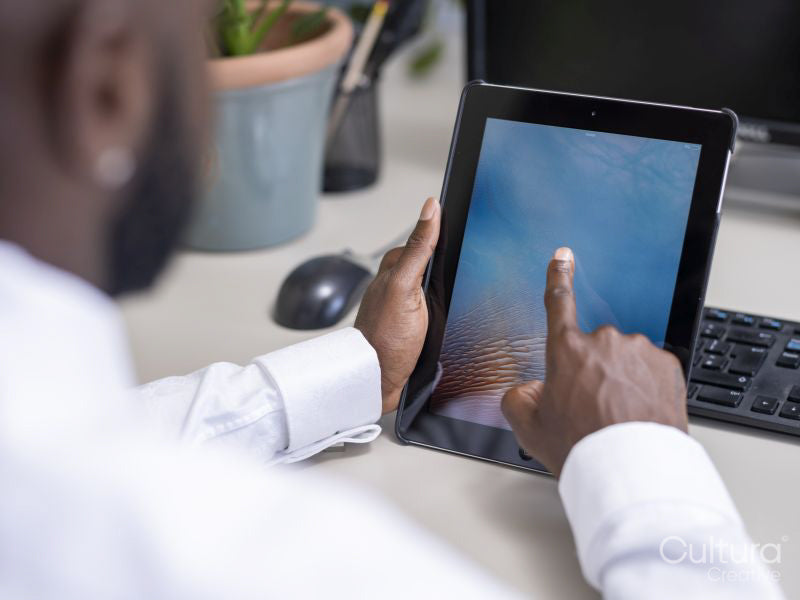 Close-up of hands using computer at desk