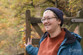 Female hiker walking through gate in forest