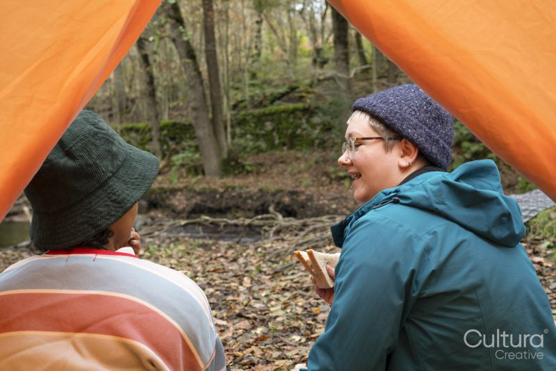 Female friends camping in forest
