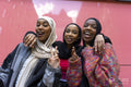 Portrait of smiling young women wearing hijabs
