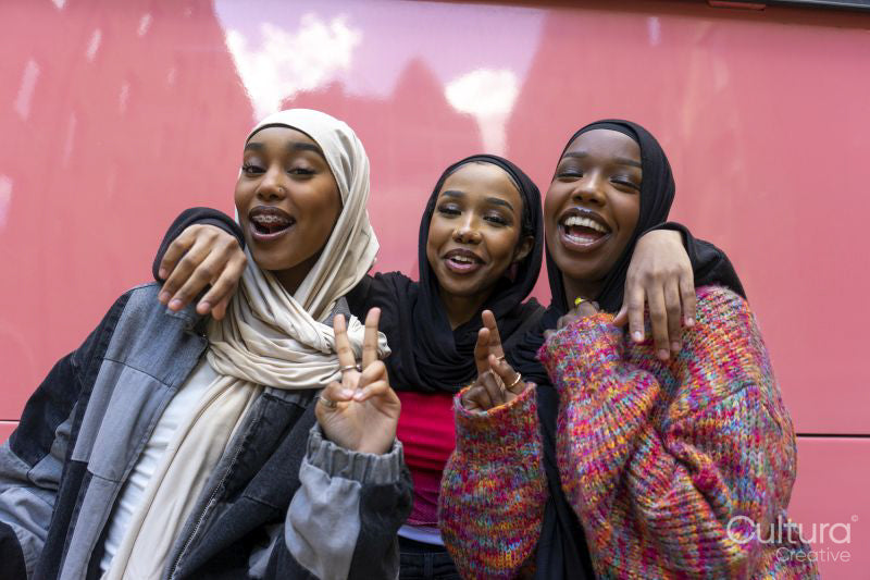 Portrait of smiling young women wearing hijabs