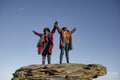 Two women standing on top of rock