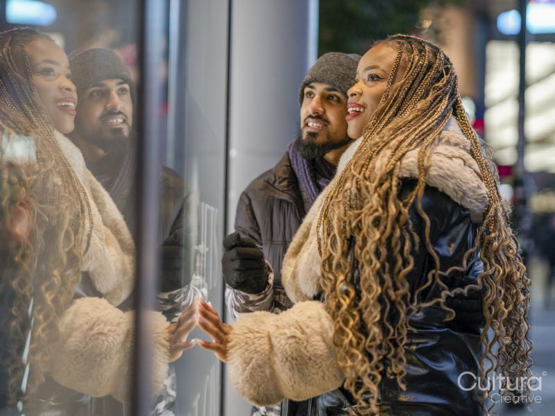 Smiling young couple window shopping