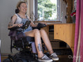 Portrait of smiling woman in electric wheelchair
