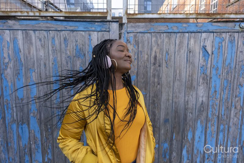 South Yorkshire, Smiling woman with braided hair and headphones