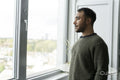Mature man looking through window