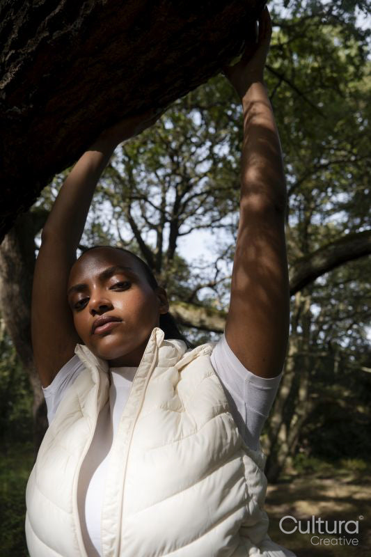 Portrait of young woman relaxing in park on sunny day