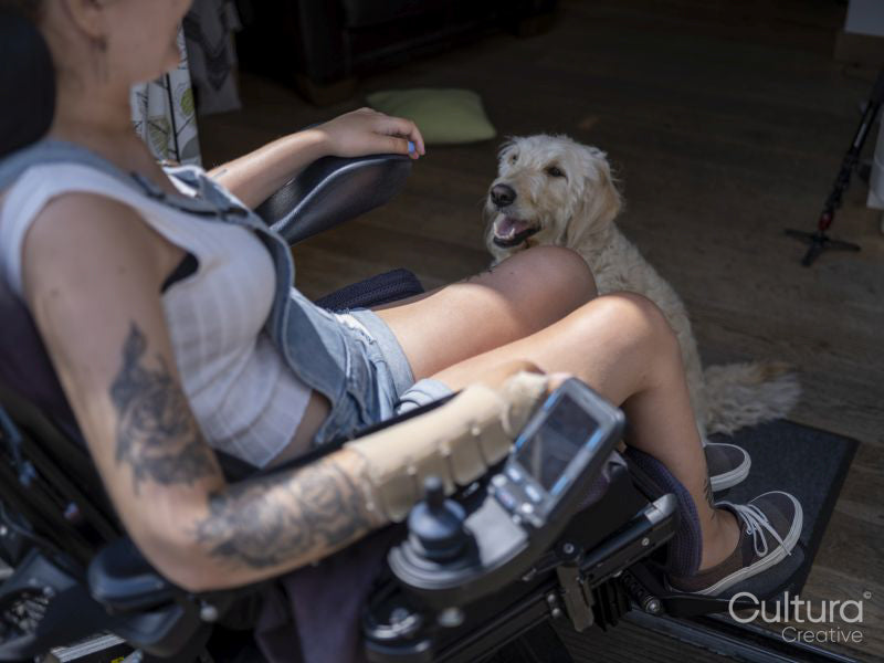 Woman in electric wheelchair with dog