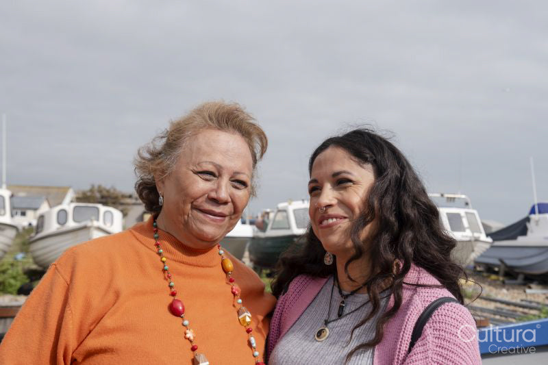 Portrait of smiling mother with daughter in harbor