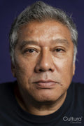 Portrait of serious man against purple background