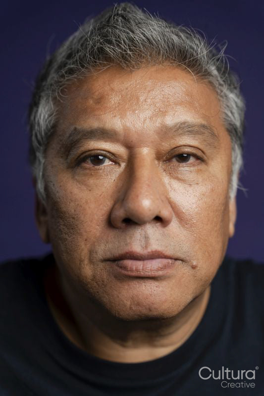 Portrait of serious man against purple background