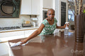 Woman cleaning kitchen counter