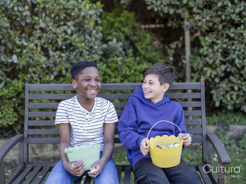 Boy friends with baskets on Easter egg hunt