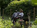 Smiling mature couple relaxing in garden in summer