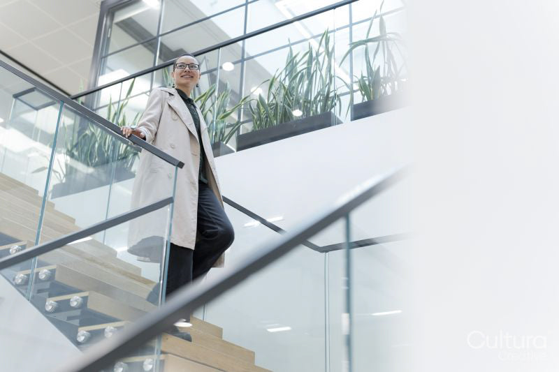 Non binary office worker walking on steps
