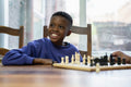 Grandmother and grandson playing chess at home