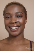 Studio portrait of smiling woman with nose ring