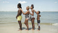Family standing in row on beach