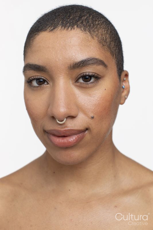 Studio portrait of woman with short hair and nose ring