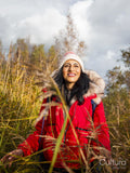 Smiling female hiker walking through tall grass