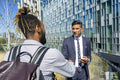 Two businessmen shaking hands in business district