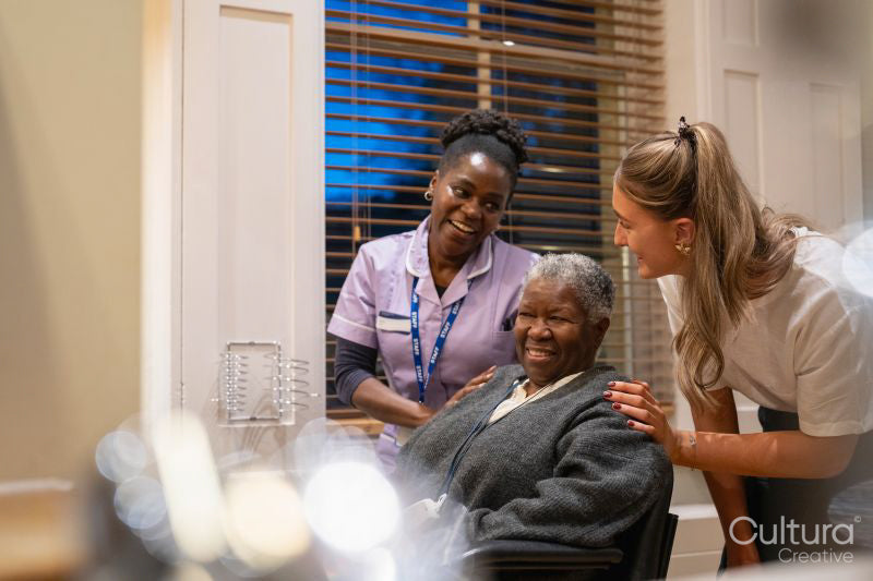 Smiling senior woman with nurse and hairdresser in hair salon