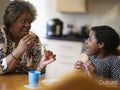 Mother and daughter eating cookies