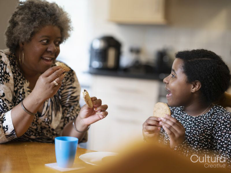 Mother and daughter eating cookies