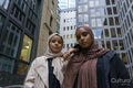 Portrait of two women wearing hijabs standing in street