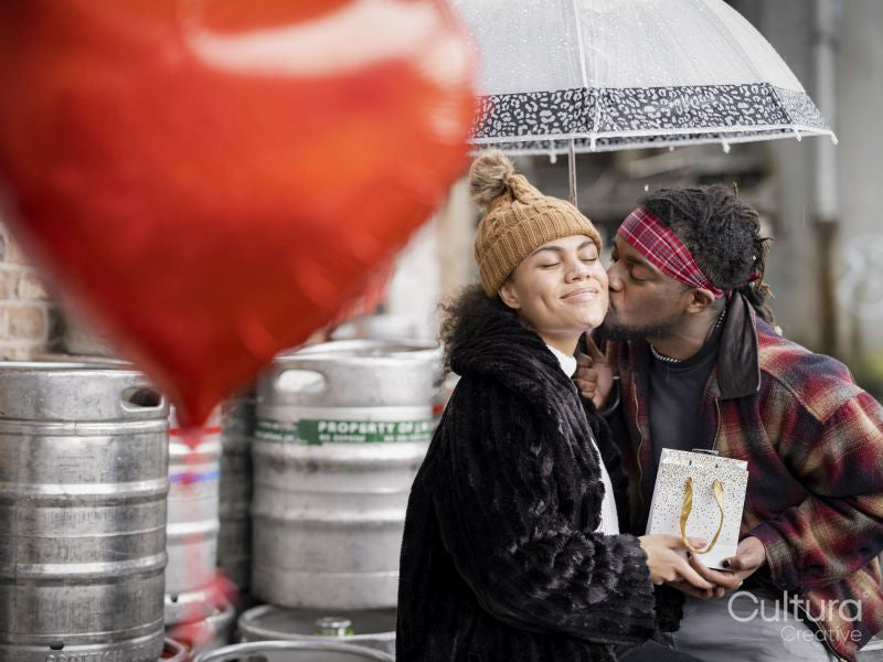 Couple celebrating Valentines Day on rainy day outdoors