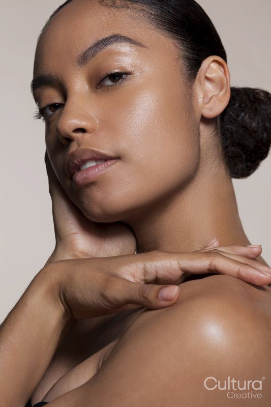 Portrait of young woman touching face