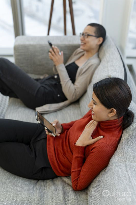 Two office workers taking break in office lobby