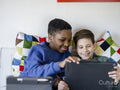 Boy friends using digital tablet at home