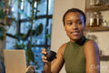 Smiling woman using laptop and drinking tea