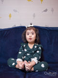 Portrait of girl with Down syndrome sitting on sofa
