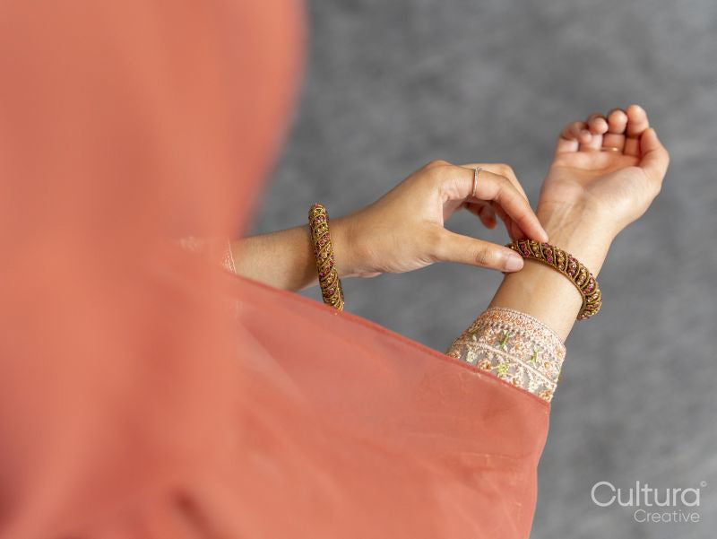 Woman adjusting bracelet on wrist