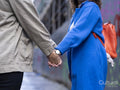 Midsection of couple holding hands