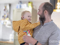 Father holding daughter with hearing aid