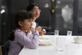 Sisters eating meal at table