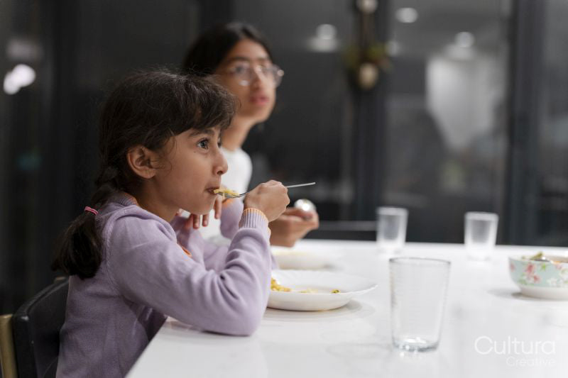Sisters eating meal at table