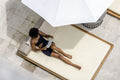 Overhead view of woman relaxing on poolside